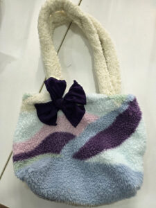 ACAP Made fluffy handmade repurposed bag in lilac, purple, blue, pink and mint with cream fluffy handles and a purple bow